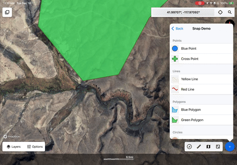 A gif of the polygon drawing process with snap to features enabled. It shows a blue polygon being drawn connected to a green polygon on the left. The video starts by connecting the new blue polygon to four vertices of the green polygon.
